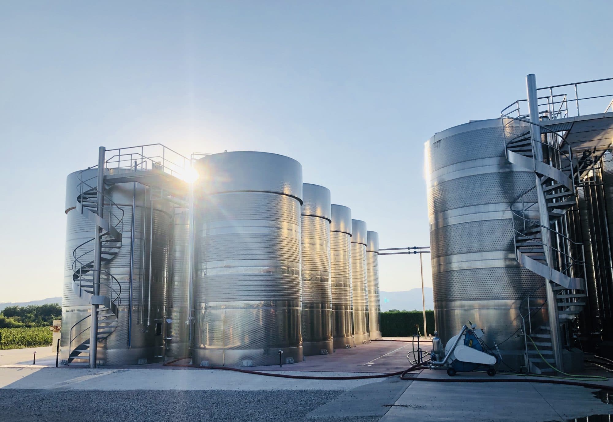 The steel tanks of the winery at sunset
